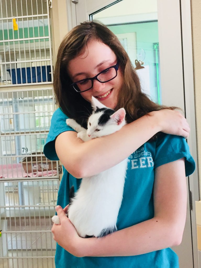 Teen volunteer with kitten