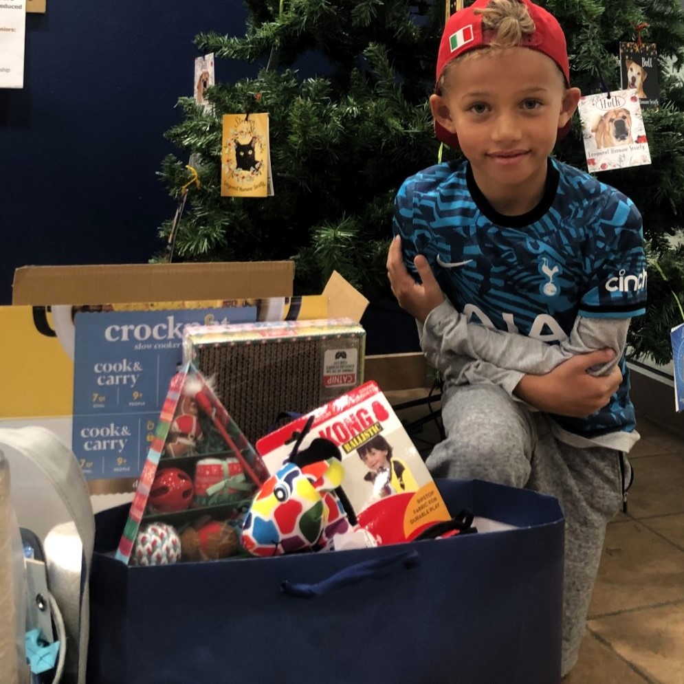 Donate supplies, young boy with box of supplies